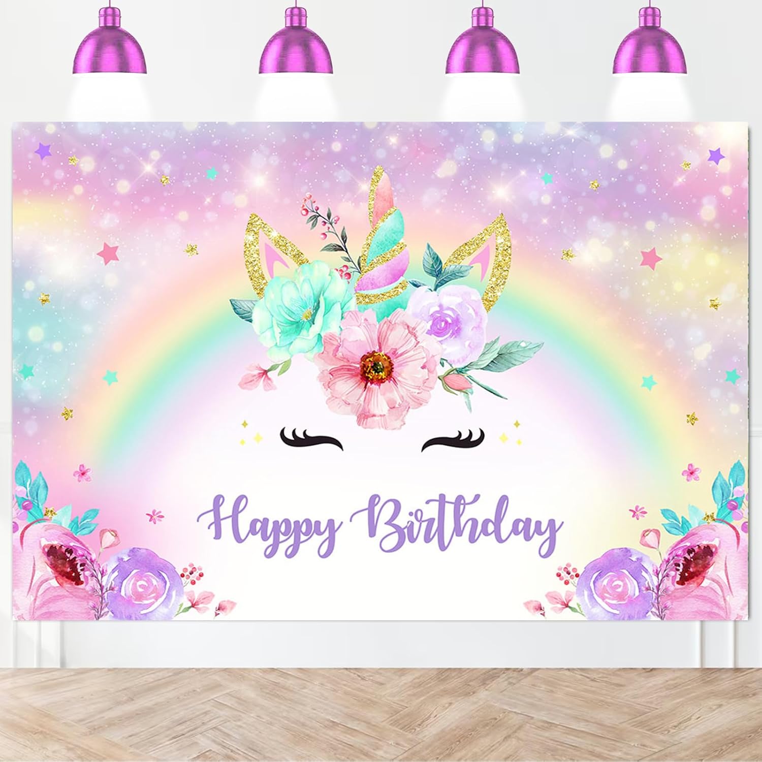 Pastel unicorn backdrop hanging behind dessert table